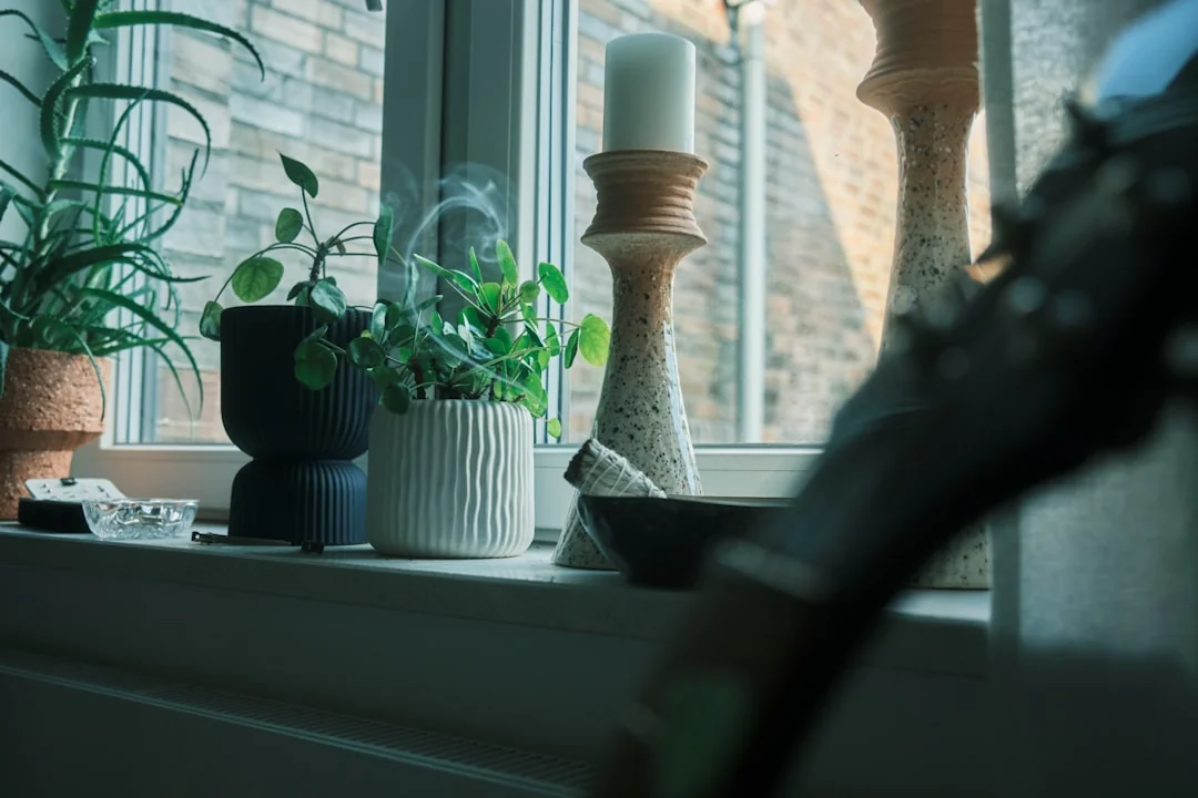 a-woman-in-a-green-shirt-and-black-gloves-vacuuming-a-gray-ottoman-5txz228u4eo